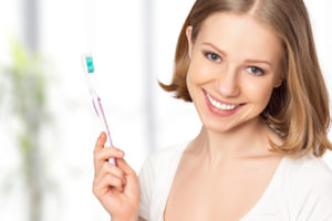 Happy Woman Holding A Toothbrush