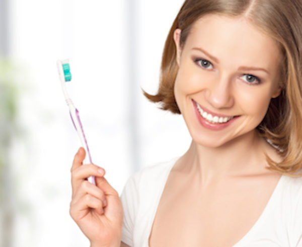 Happy Woman Holding A Toothbrush