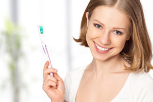 Young Woman Smiling with Toothbrush