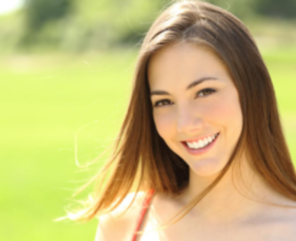Young Brunette Woman Smiling At You Outside