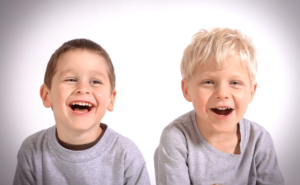 Two young boys laughing at camera